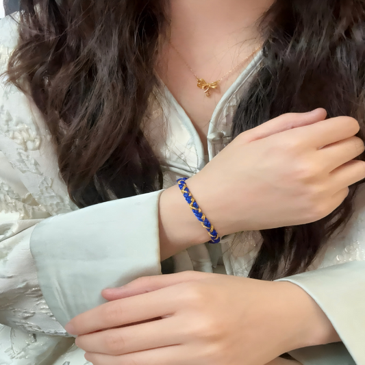 Wearing red string on left wrist — daily anchor for protection, luck, and spiritual guidance