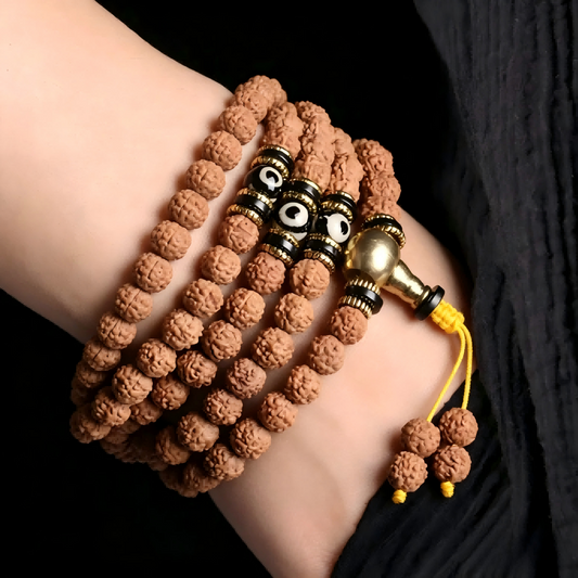 Woman wearing Rudraksha Dzi mala on left wrist for grounding and protection